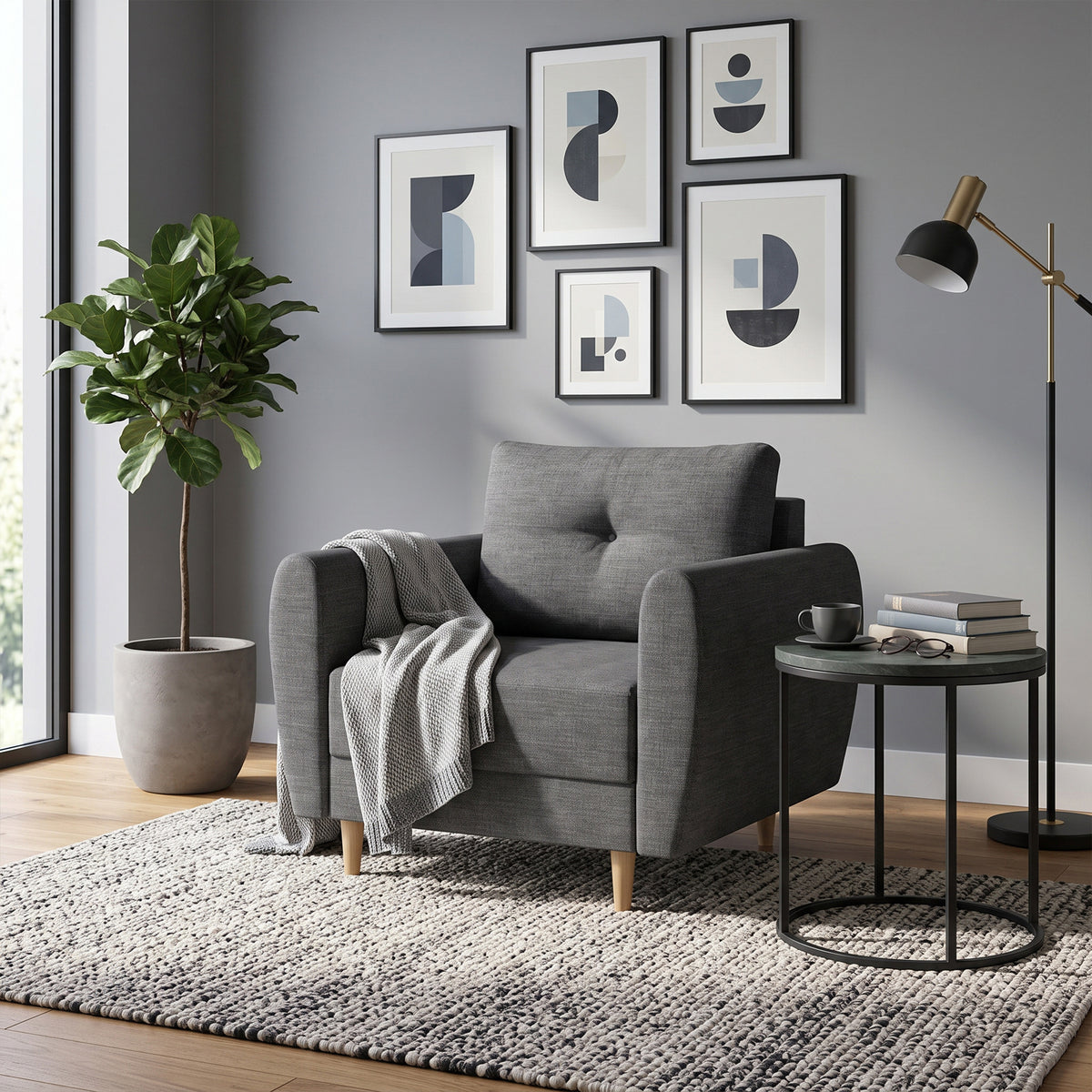The Harmi armchair (90 cm) in the living room, with a gallery of prints, a plant and a side table with books – a reading armchair