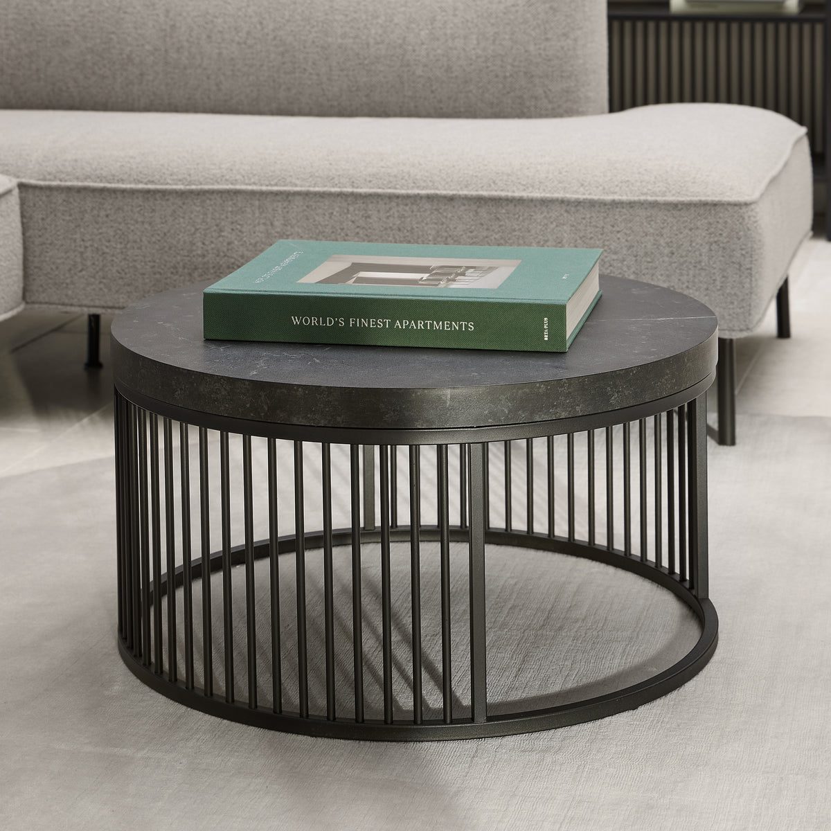 Cella Round Coffee Table with a Black Marble Effect, Modern Style – in a room setting