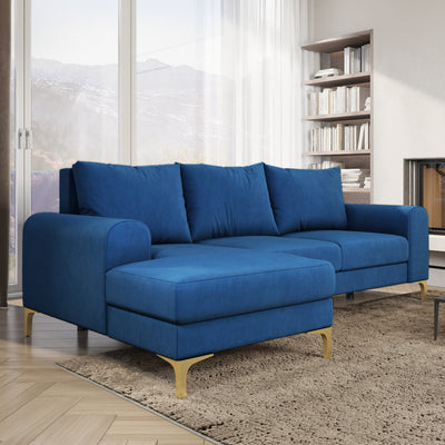 Arpelo 245x145 corner sofa Midnight Sapphire (MANILA 26) in a bright living room with a bookcase and a rug – a velour corner sofa