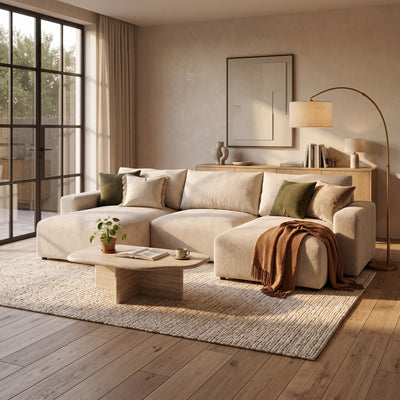 U Iskeli corner sofa in Creamy Taupe (ARAGON 03) in a bright living room with a stone coffee table, a lamp and a blanket – corner sofa for the living room