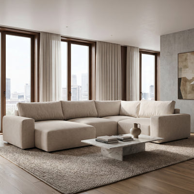 UL Iskeli Plus Creamy Taupe (ARAGON 03) left-hand corner sofa in a living room with large windows and a marble coffee table