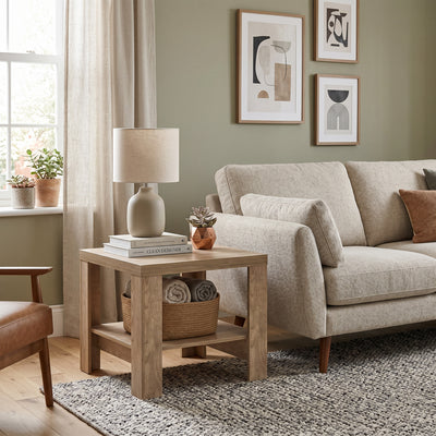 Korin coffee table 65x57 in a living room with a bouclé sofa and a leather armchair – small living room coffee table