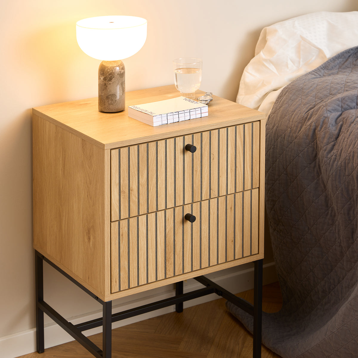 Bambouz 46x70 bedside table in the bedroom next to the bed, with a lamp, books and a glass – a bedside table with drawers