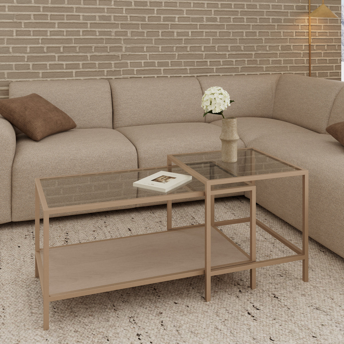 A set of Skeleto coffee tables (90x45 and 50x50) in front of a beige corner sofa, a brick wall and a vase of flowers